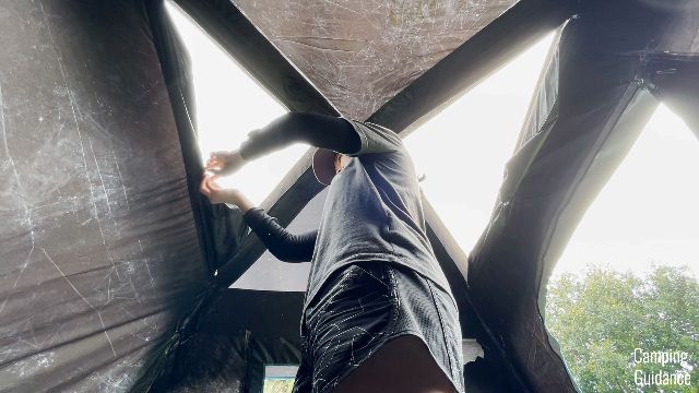 The author opening up the skylight windows in the Ozark Trail Dark Rest Instant Cabin 6