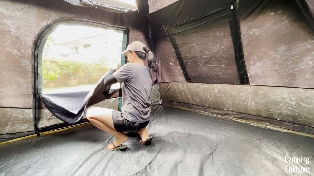 The author opening up one of the windows in the Ozark Trail Dark Rest Instant Cabin 6
