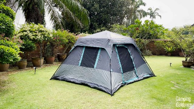 The Ozark Trail Dark Rest Instant Cabin 6 in light rain