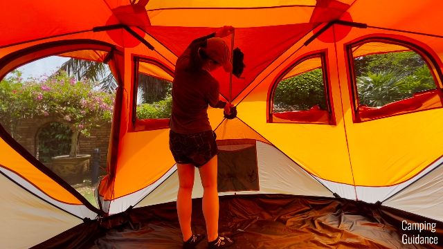 The author measuring the width of one of the pockets in the Gazelle T4 Hub Tent