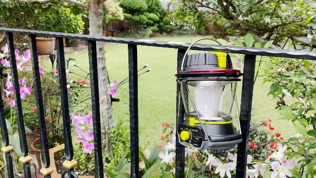 The Goal Zero Lighthouse 600 lantern hanging from a metal railing