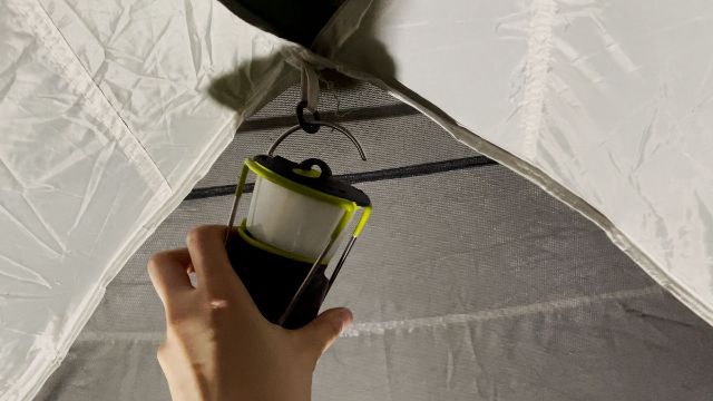The Goal Zero Lighthouse Mini hanging from a tent's lantern loop