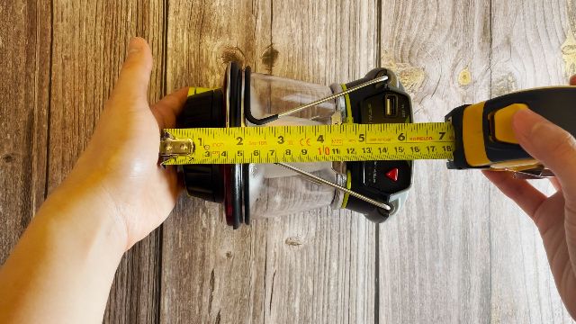The author measuring the packed size of the Goal Zero Lighthouse 600 lantern