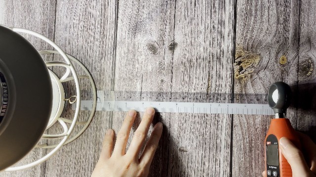 The author measuring the lumen output of the Barebones Railroad lantern.