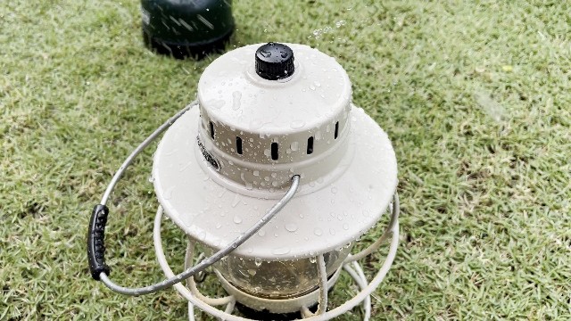 The author putting the Barebones Railroad lantern through a rain test.