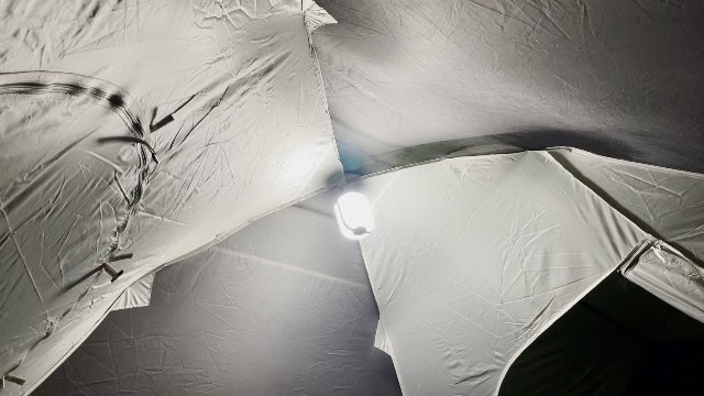 The BioLite AlpenGlow 500 hanging at the top of a tent.
