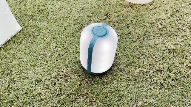 The author putting the BioLite AlpenGlow 500 through a heavy rain test.