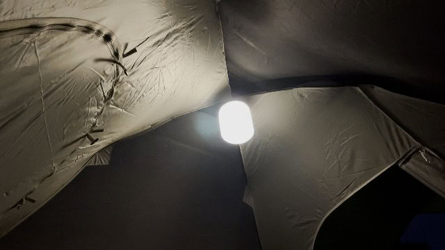 The BioLite Luci Charge 360 lantern hanging at the top of a tent.