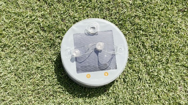 The author charging the BioLite Luci Charge 360 lantern via solar energy.