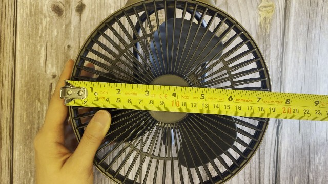 The author measuring the size of the face of the Claymore Portable Fan V600+.