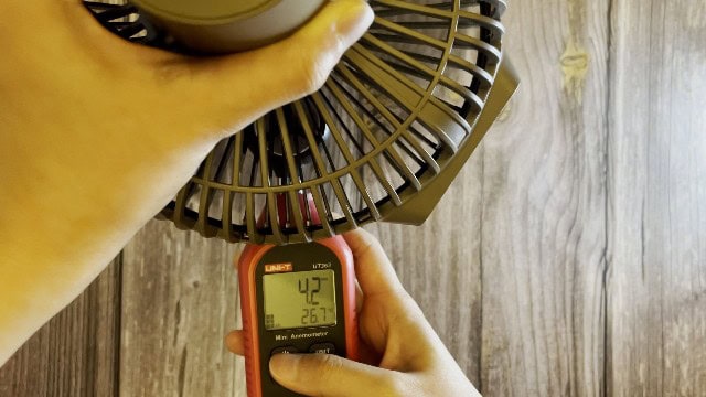 The author measuring the fan speed of the Claymore Portable Fan V600+.