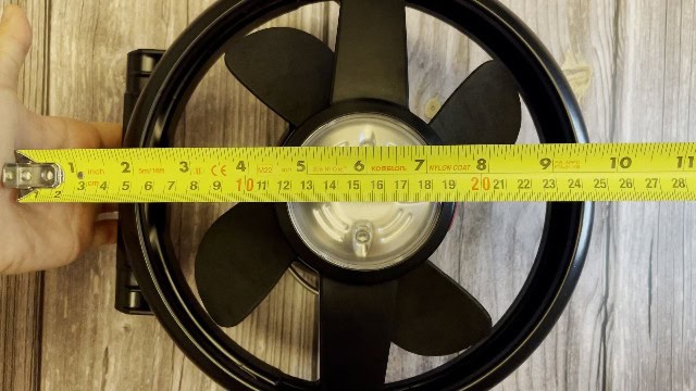 The author measuring the size of the face of the Coleman CPX 6 Lighted Tent Fan.