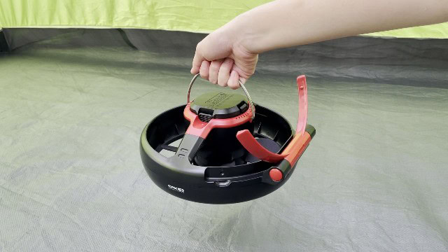 The author holding the handle of the Coleman CPX 6 Lighted Tent Fan.