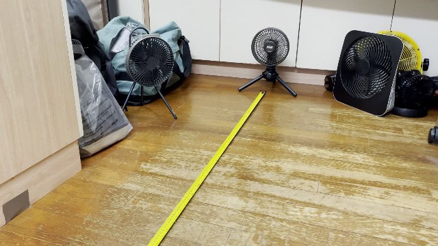 The author measuring the airflow distance of the Coleman OneSource Fan.