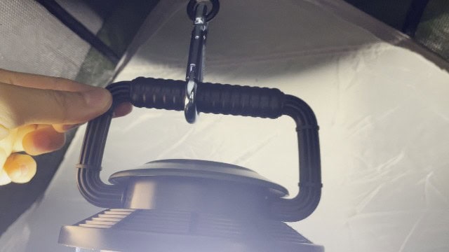 The Coleman Rugged Rechargeable 400 Lantern hanging at the top of a tent.