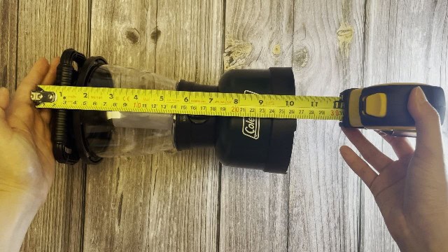 The author measuring the packed size of the Coleman Rugged Rechargeable 400 Lantern.
