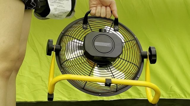 The author holding the handle of the Geek Aire Portable Camping Fan.