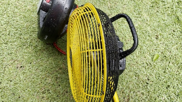 The author rain testing the Geek Aire Portable Camping Fan.