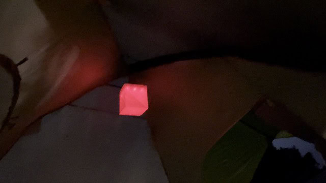 The LuminAID PackLite Titan on its dimmest red setting, at the top of a tent.