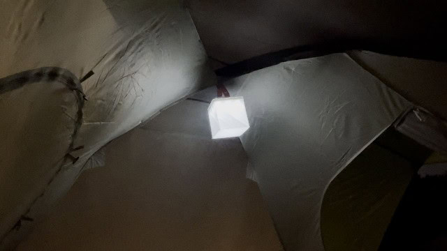 The LuminAID PackLite Titan on its dimmest white setting at the top of a tent.