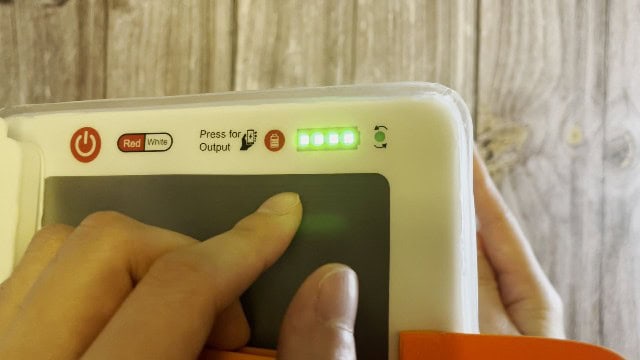 The 'press for output' button of the LuminAID PackLite Titan.