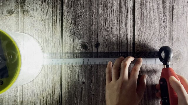 The author measuring the lumen output of the MPOWERD Luci Pro Outdoor lantern.