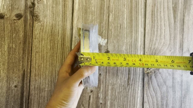 The author measuring the packed size of the MPOWERD Luci Pro Outdoor lantern.