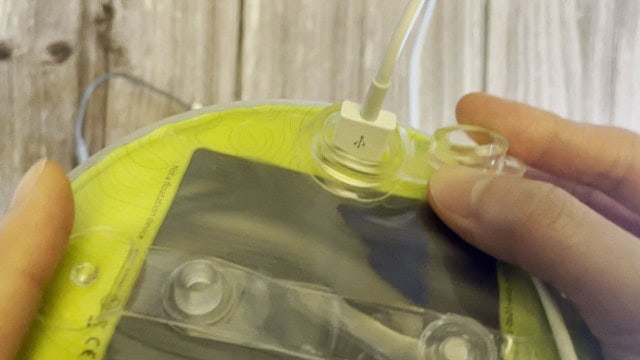 The author charging her phone using the MPOWERD Luci Pro Outdoor lantern.