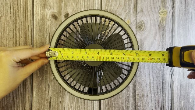 The author measuring the size of the Nitecore NEF10 Fan.