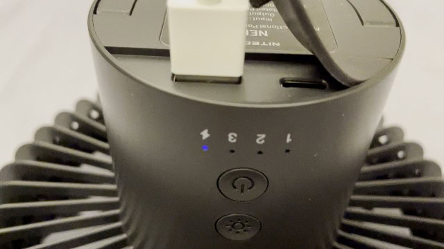The author using the Nitecore NEF10 Fan to charge a mobile phone.