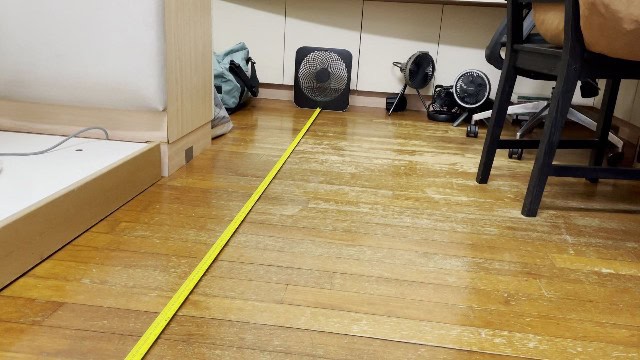 The author measuring the airflow distance of the O2Cool Treva Fan.