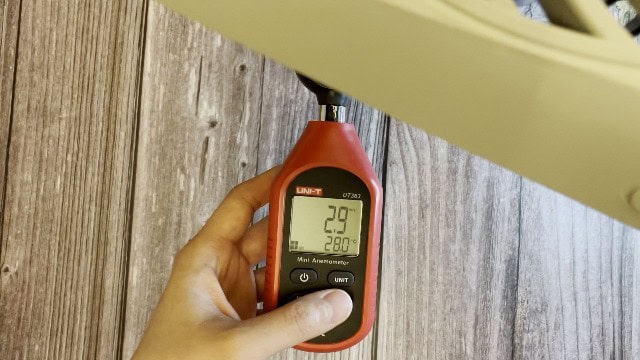 The author measuring the fan speed of the O2Cool Treva Fan.