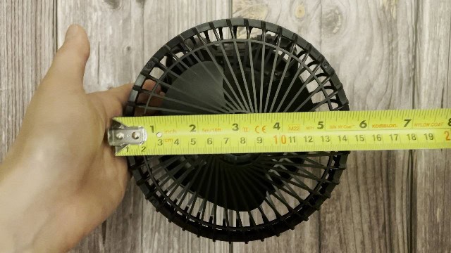 The author measuring the fan size of the Odoland Camping Fan.