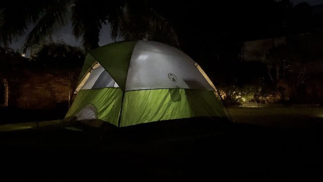 The author using the Odoland Camping Fan for tent camping.