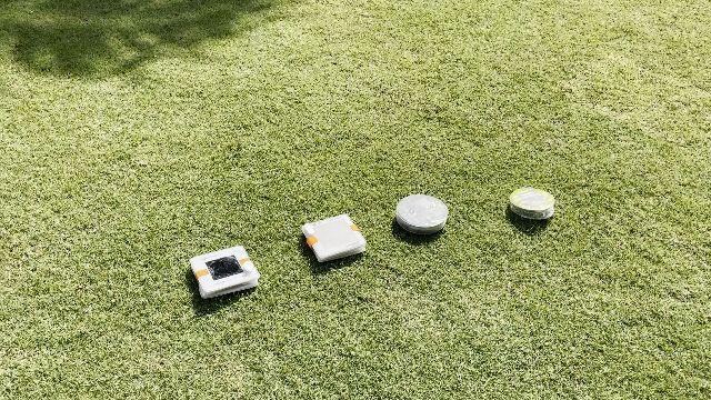 The author charging 4 solar lanterns in the sun.