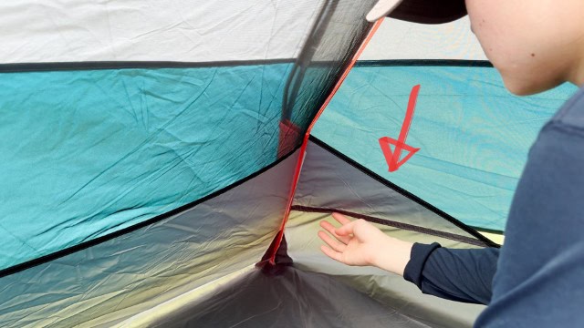 The author pointing to the Kelty Late Start 2's tub floor.