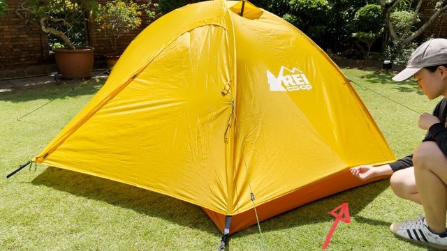 The author is pulling away the tent width of the REI Trailmade 2.